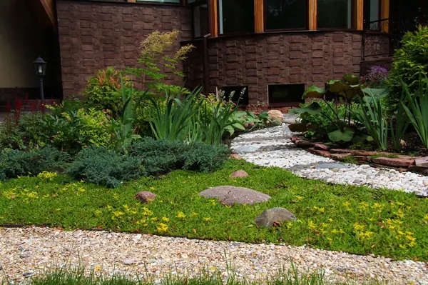 Modern house with a big flowerbad with a sphere