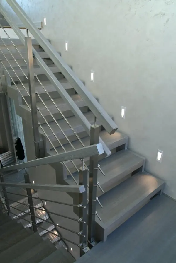 Modern metal stair covered by patina oak