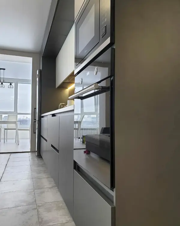 Прямая темная кухня с матовыми фасадами в сером цвете