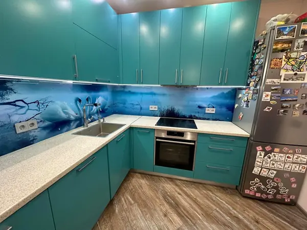 Glass backsplash in a blue kitchen