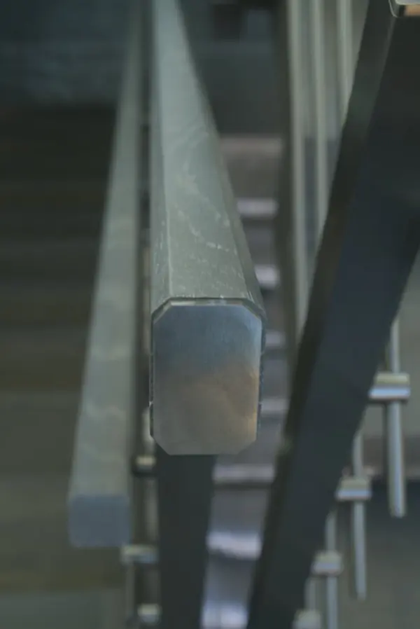 Modern metal stair covered by patina oak