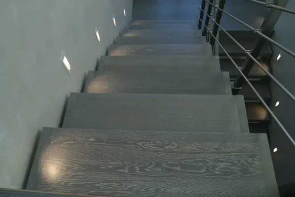 Modern metal stair covered by patina oak