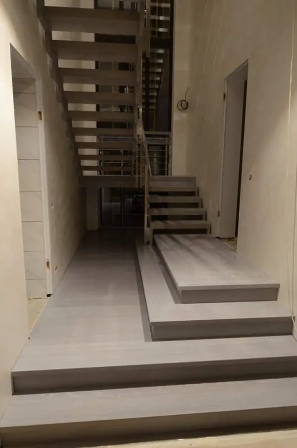 Modern metal stair covered by patina oak