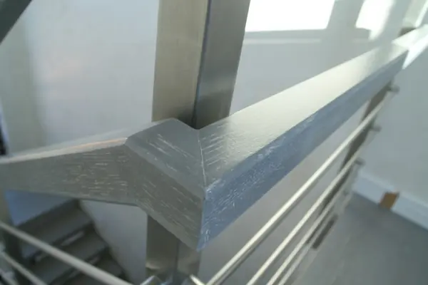 Modern metal stair covered by patina oak