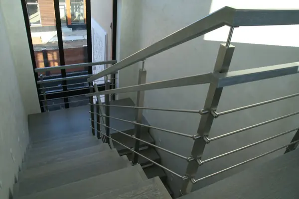Modern metal stair covered by patina oak
