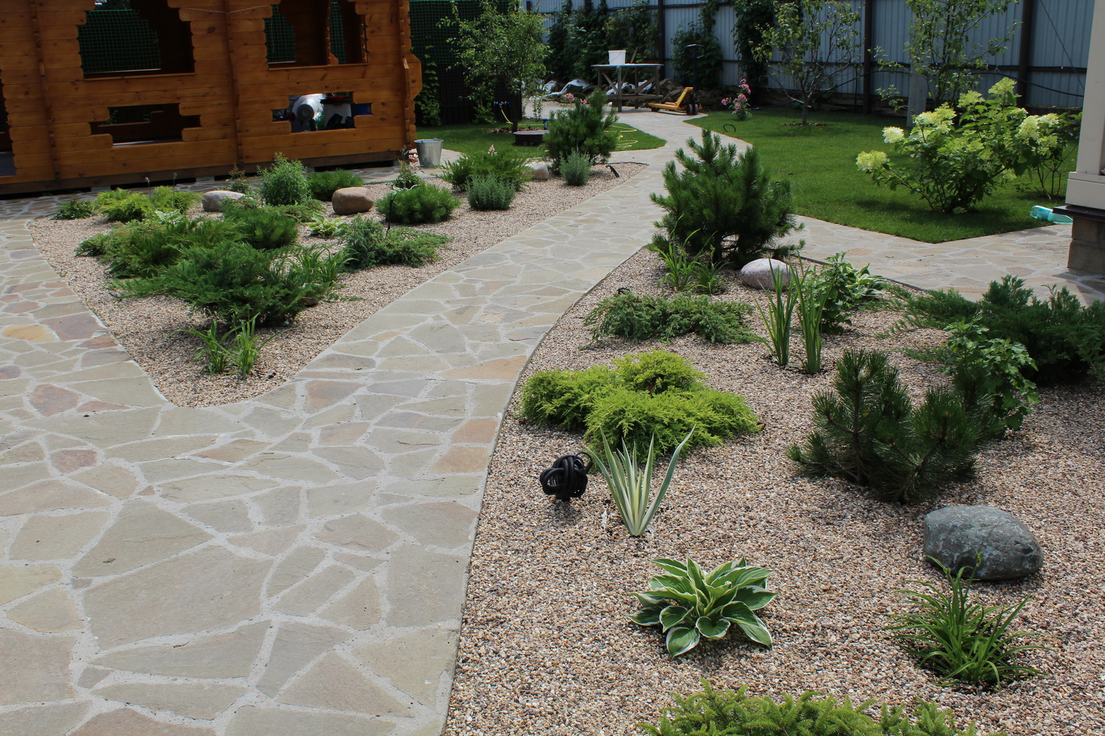 Каменистые клумбы и дорожки из натурального камня