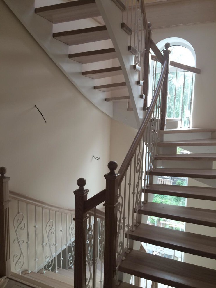 Две лестницы в одной лестничной клетке с элегантными металлическими балясинами