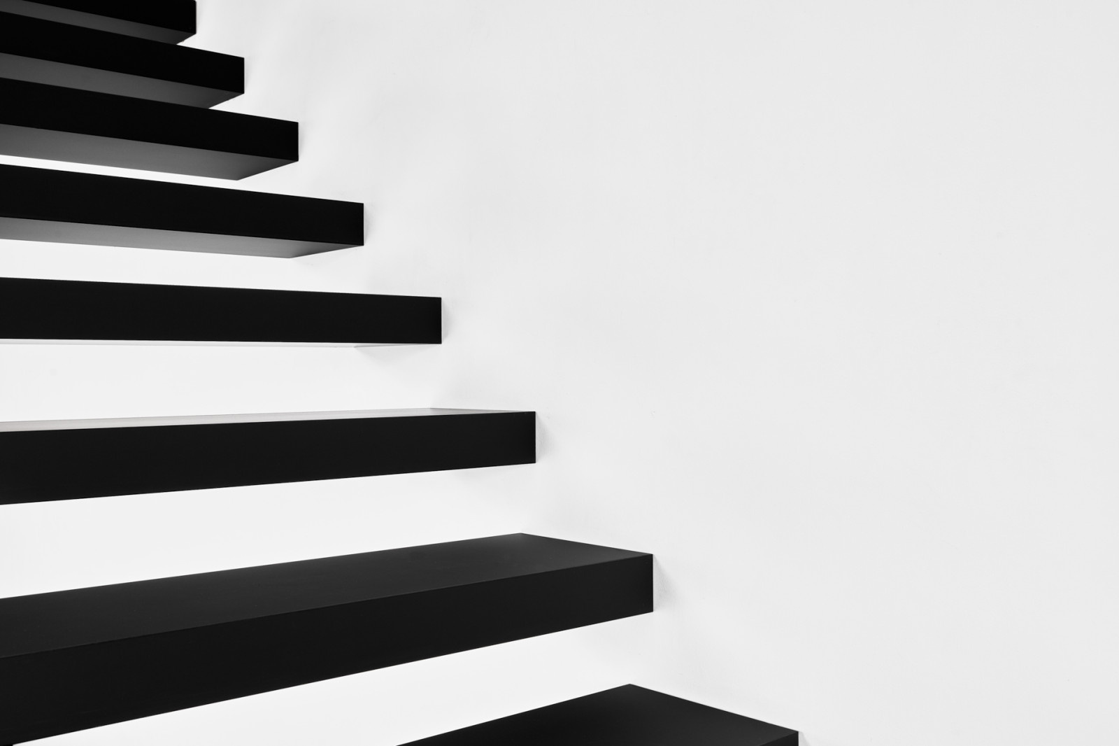 Консольная лестница в черном матовом цвете с ограждением из белого стекла