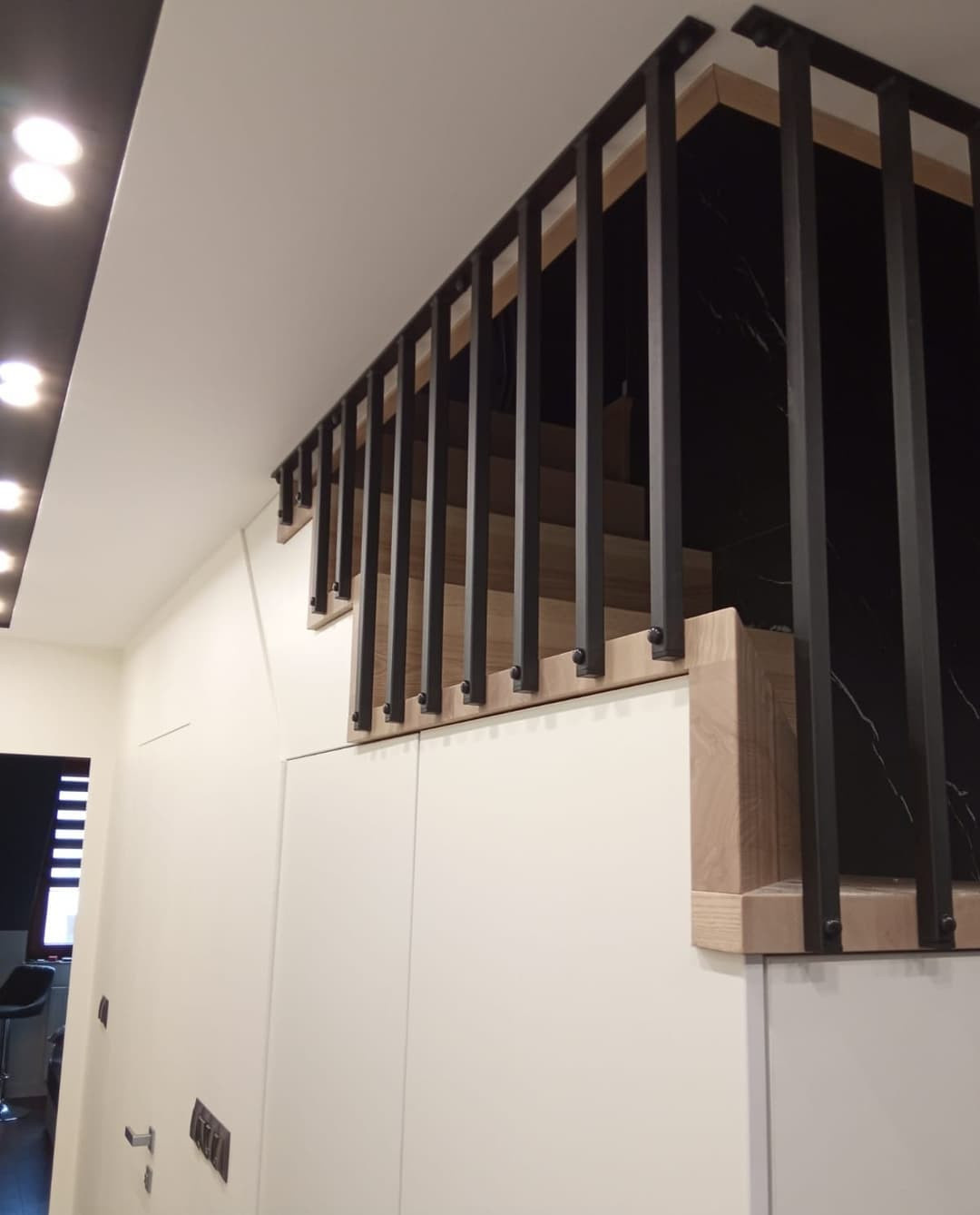 Закрытая лестница с металлическими перилами