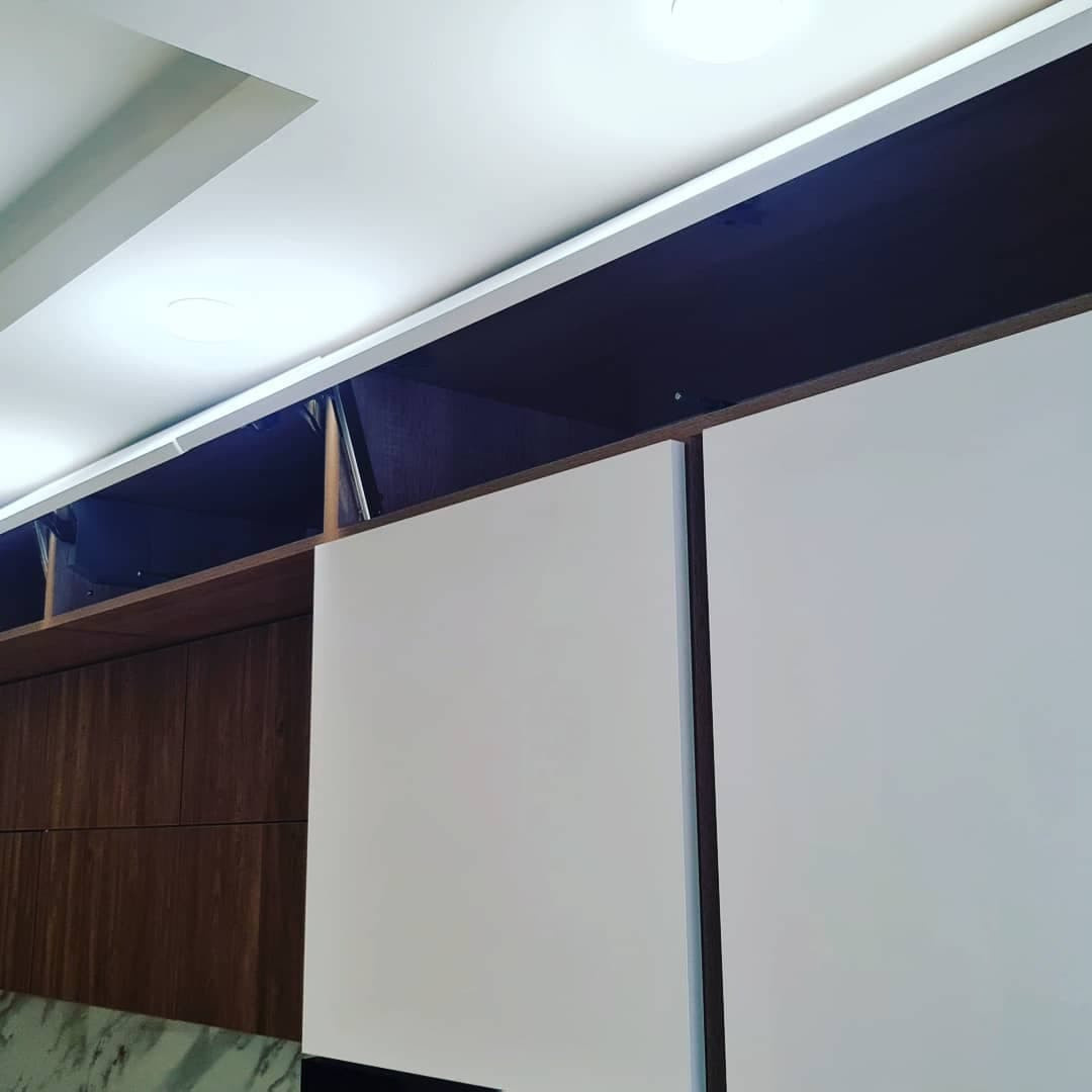 Уютная угловая кухня с фасадами под дерево и серыми матовыми фасадами