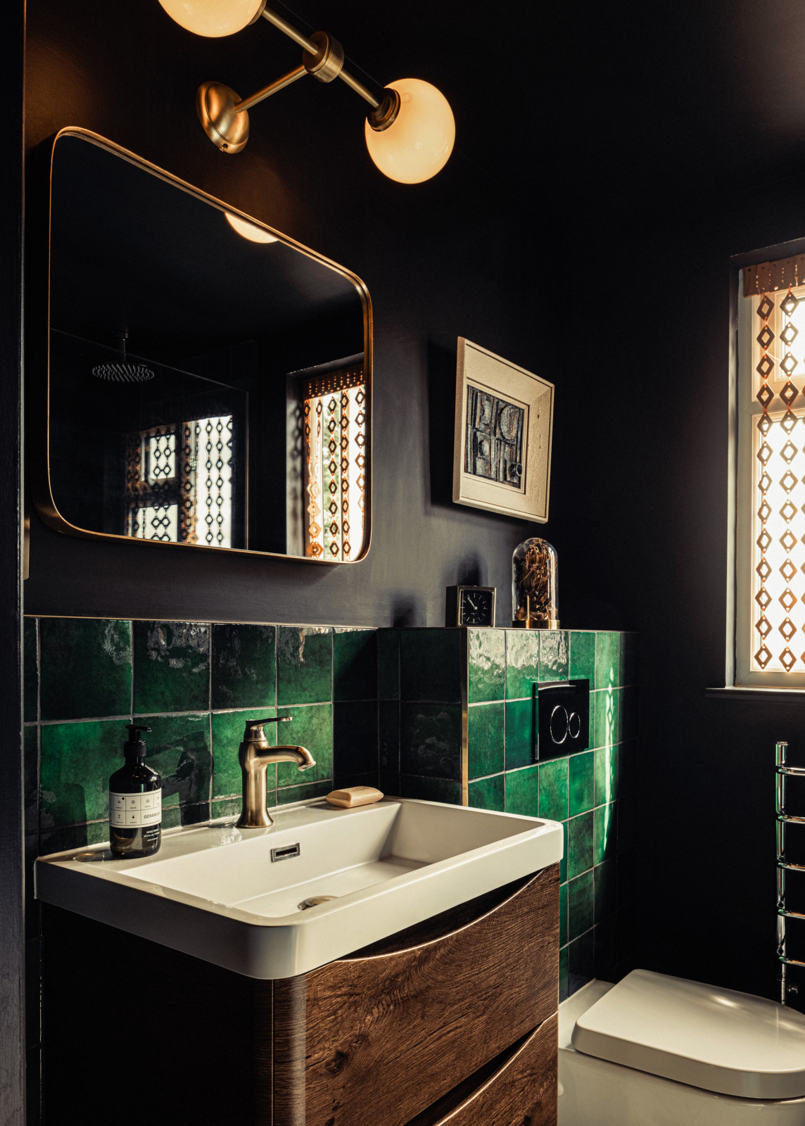 Dark bathroom with green tiles
