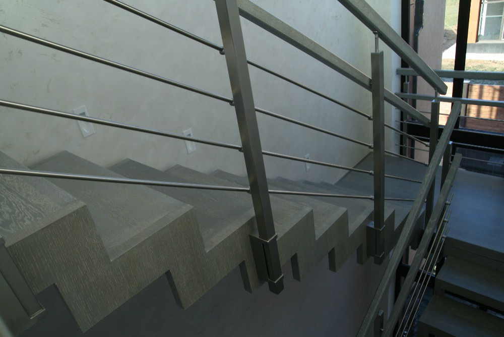 Modern metal stair covered by patina oak