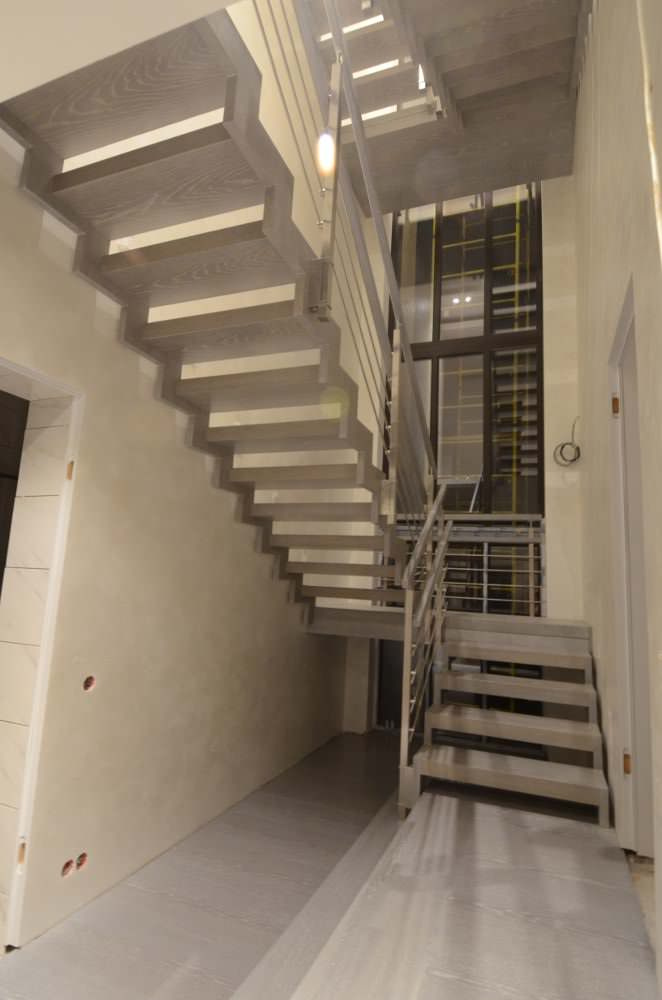 Modern metal stair covered by patina oak