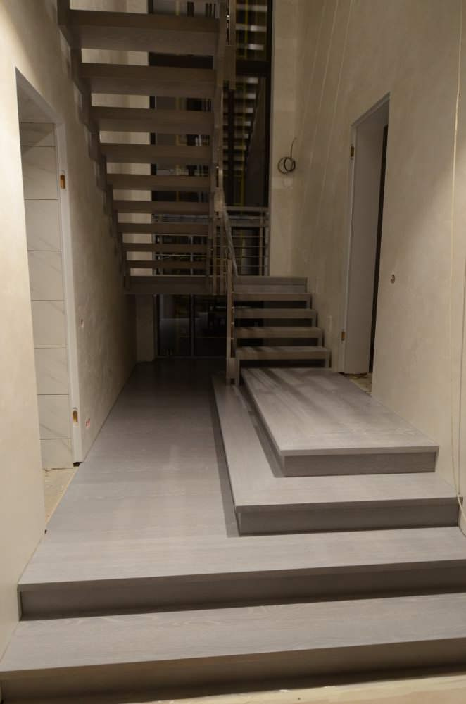 Modern metal stair covered by patina oak