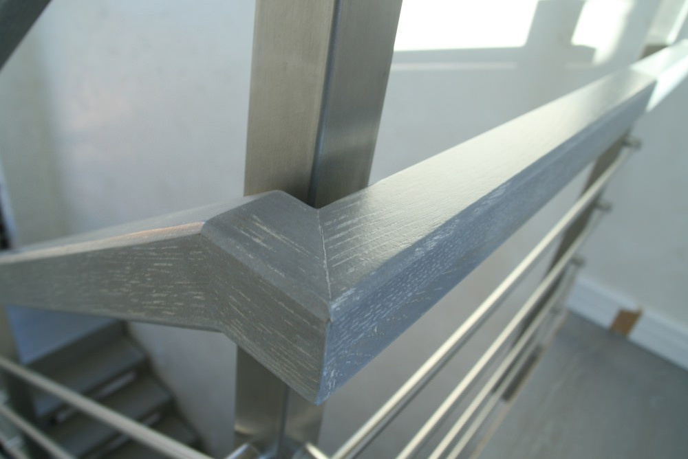 Modern metal stair covered by patina oak