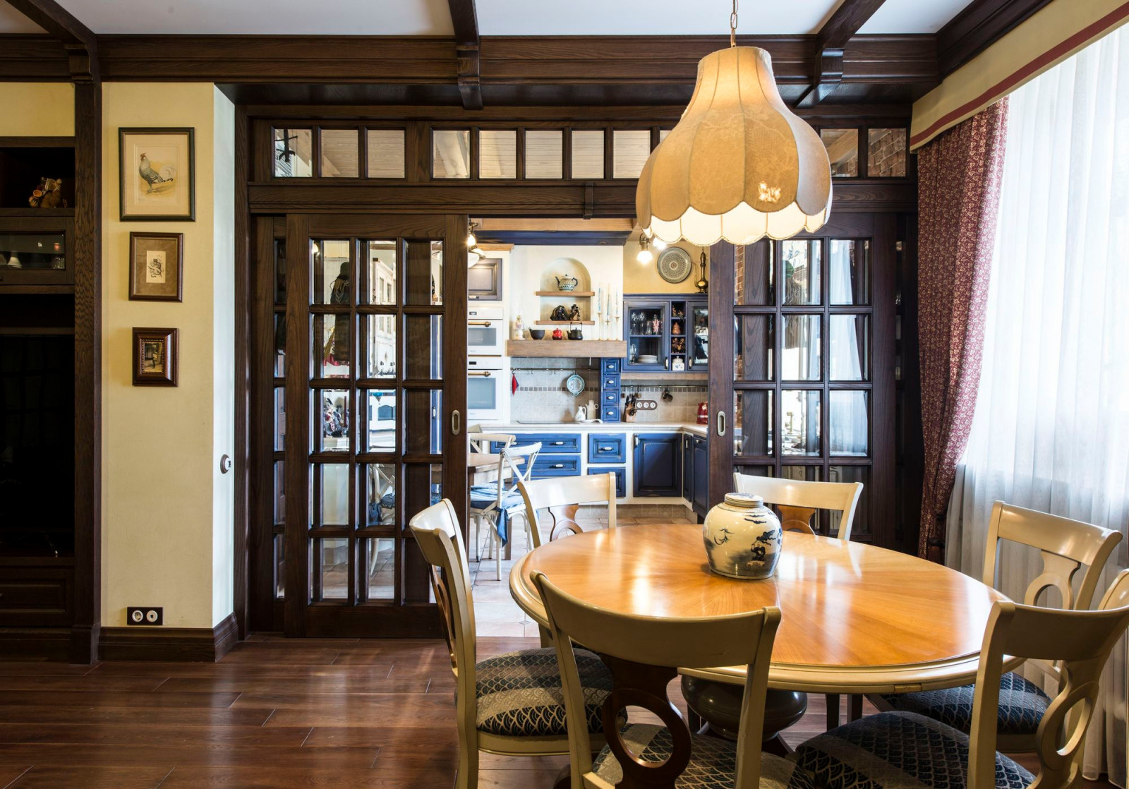 Кухню от гостиной отделяет остекленный витраж с раздвижными дверцами