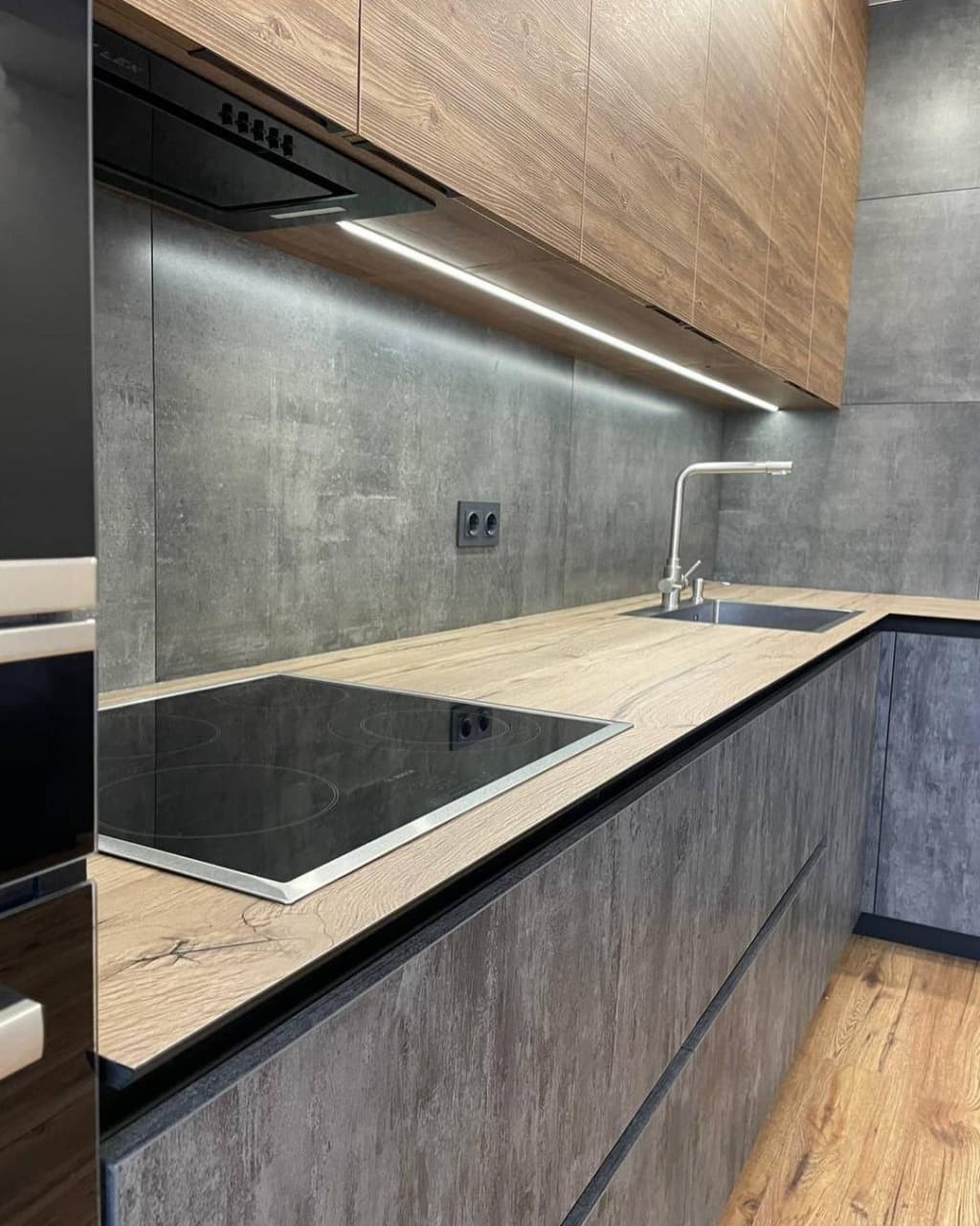 Большая угловая встроенная кухня в черном и коричневом цвете с витриной