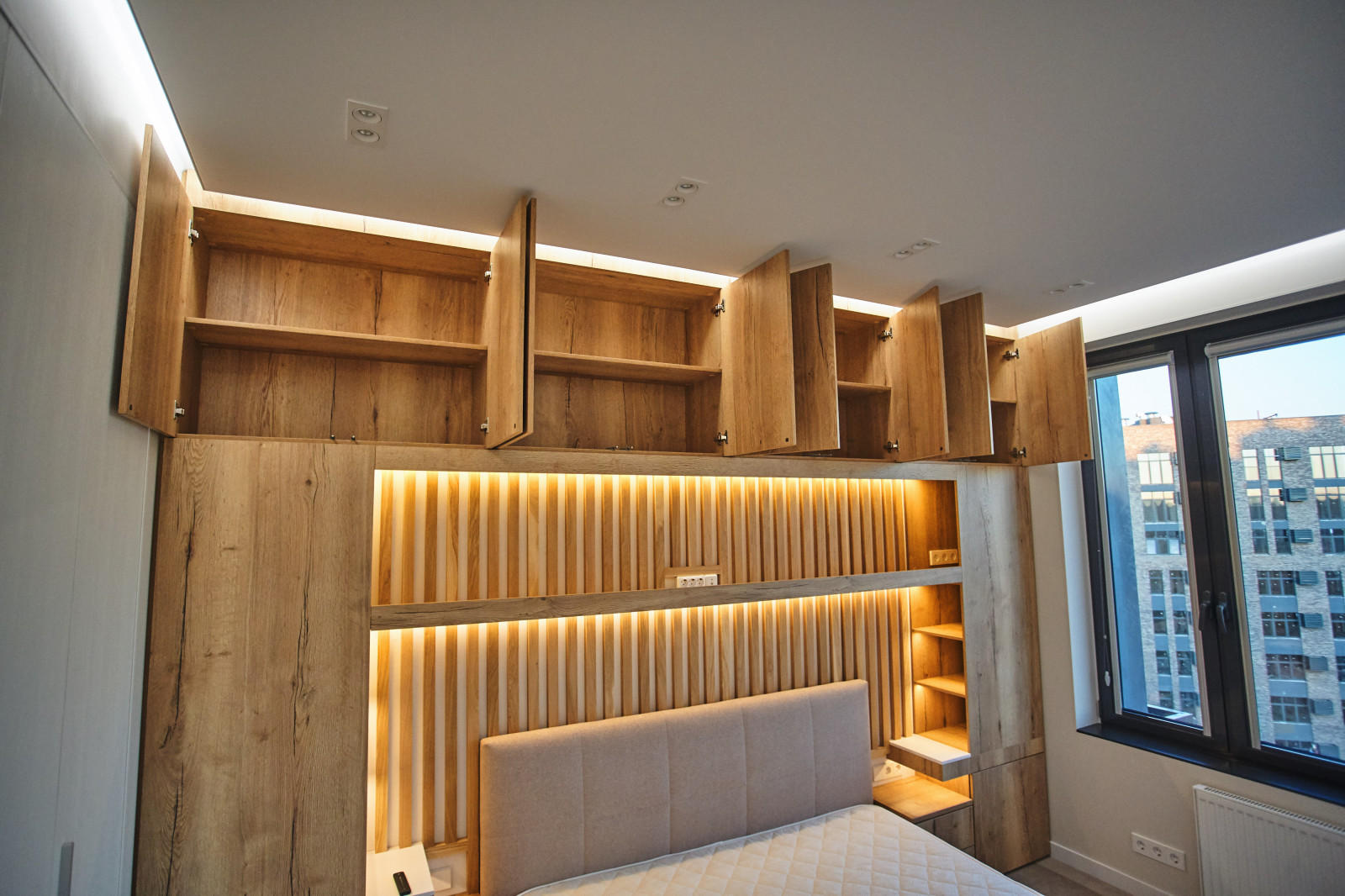 Вместительная система хранения у изголовья кровати с подсветкой