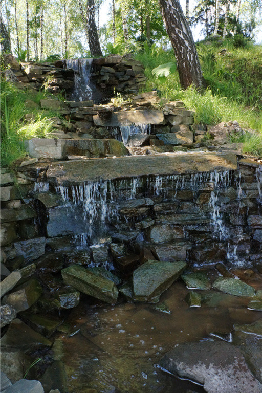 PlayPrevious8/13Next Водный каскад на естественном склоне в лесной части участка