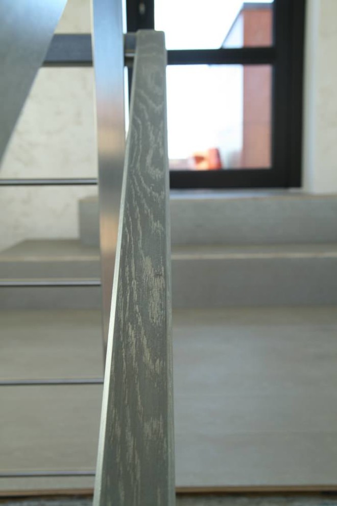 Modern metal stair covered by patina oak