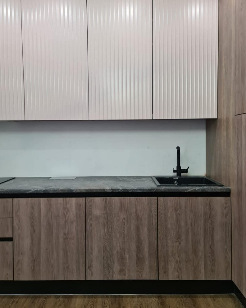 Большая угловая кухня в сером цвете с рифлеными фасадами и витриной