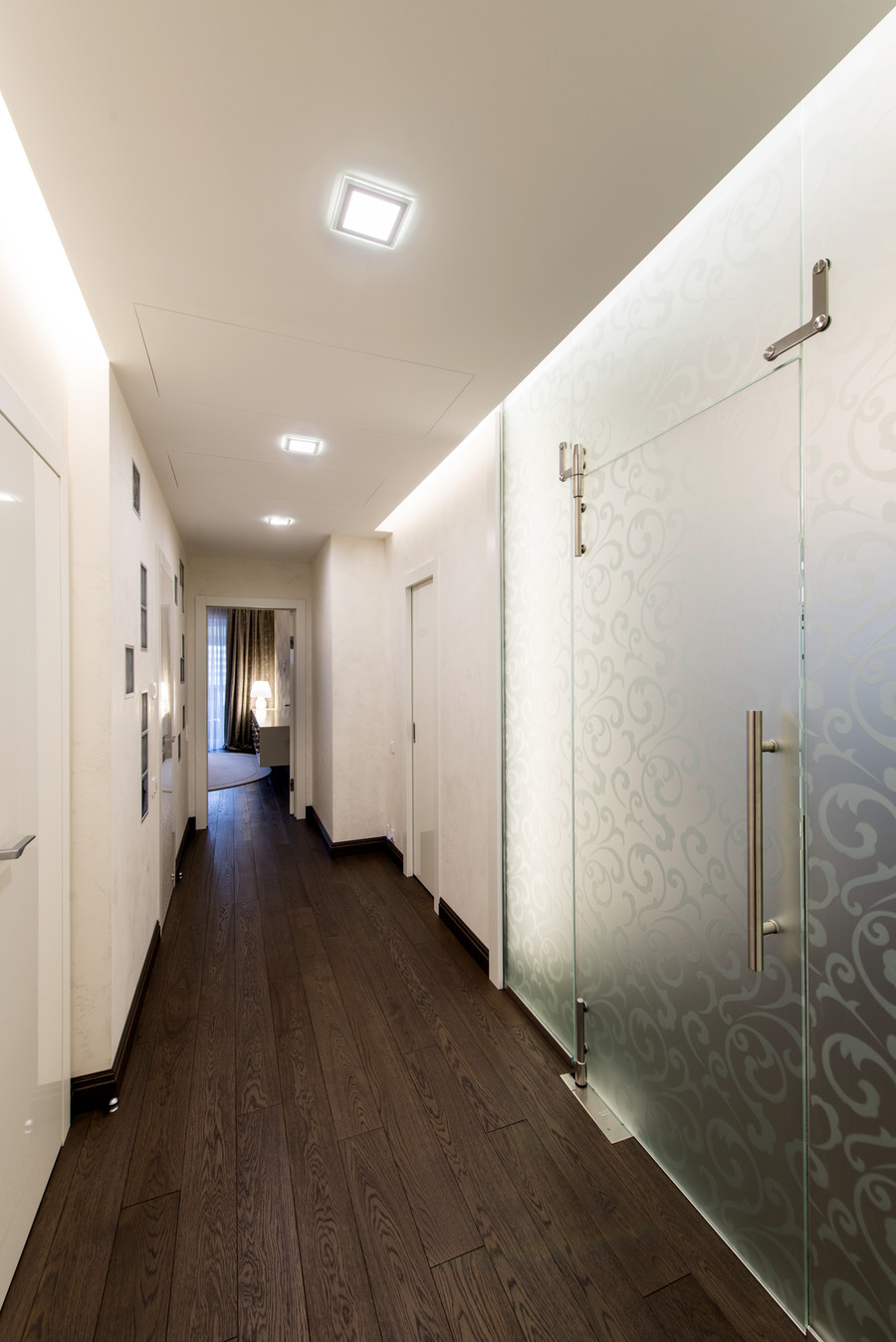 Коридор в интимной зоне квартиры отделен от зоны гостиной стеклянной перегородко