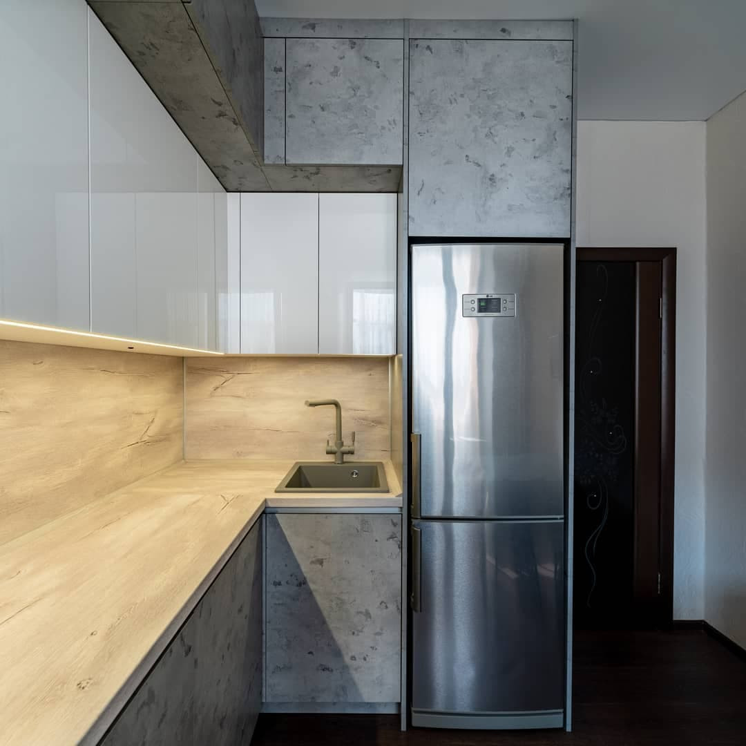 Угловая встроенная кухня с белыми глянцевыми и каменными фасадами