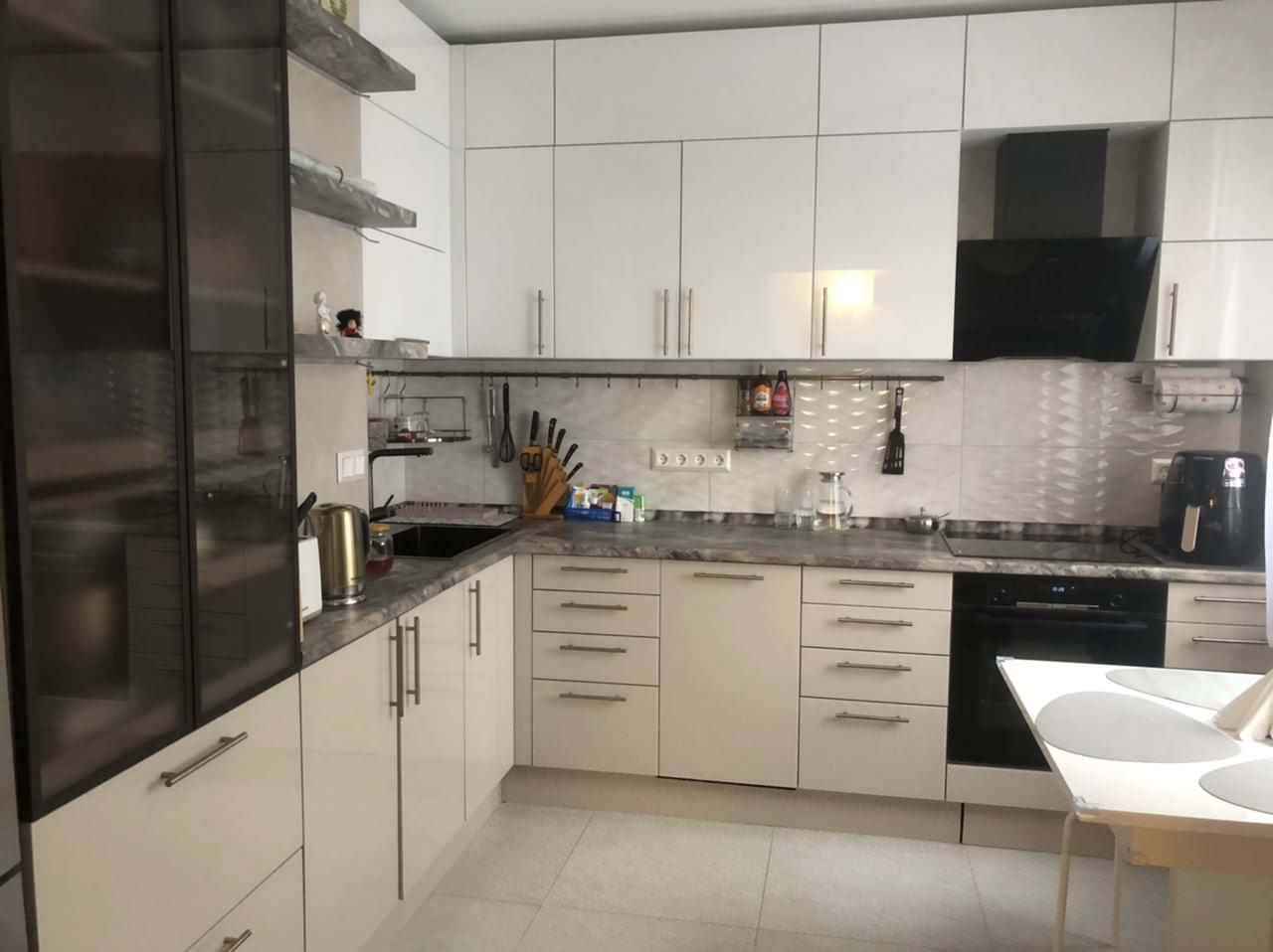 Угловая кухня в светлых тонах с тонированным стеклом