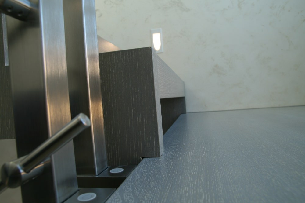 Modern metal stair covered by patina oak