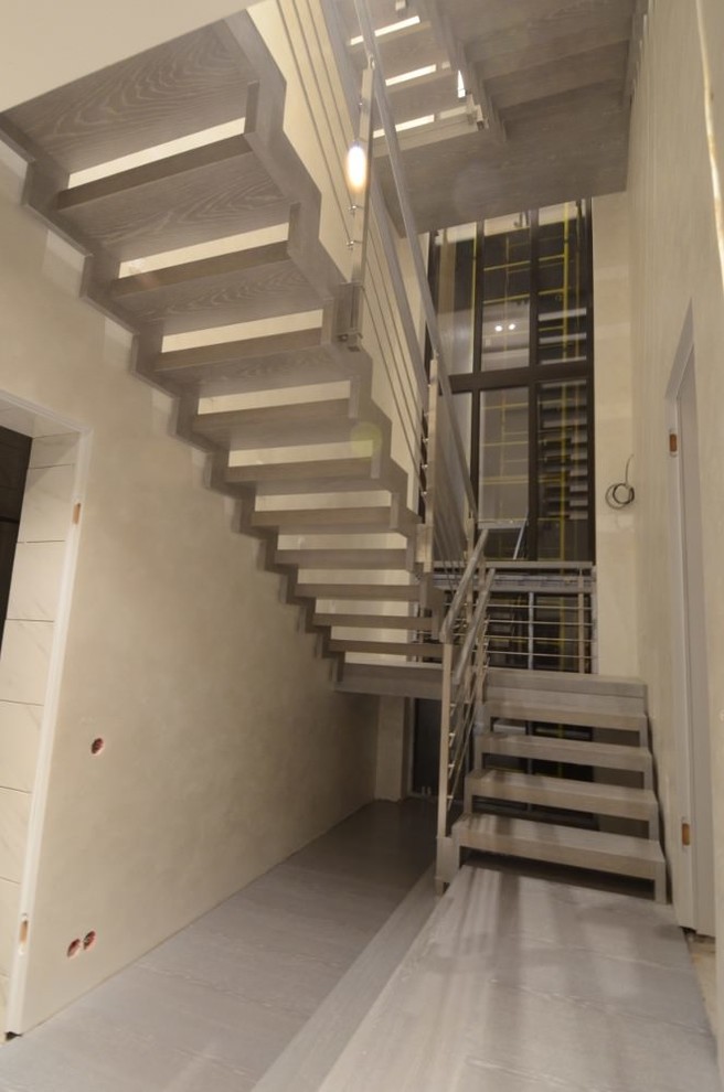 Modern metal stair covered by patina oak