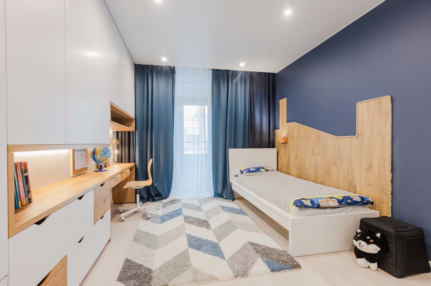 Children's room for a boy with a blue wall in a modern style