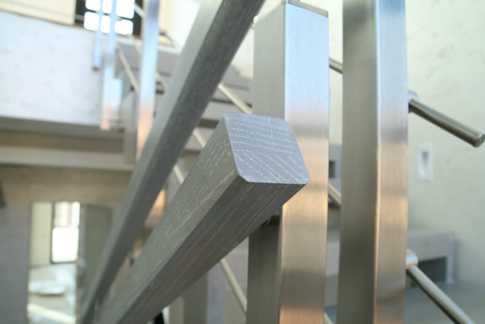 Modern metal stair covered by patina oak