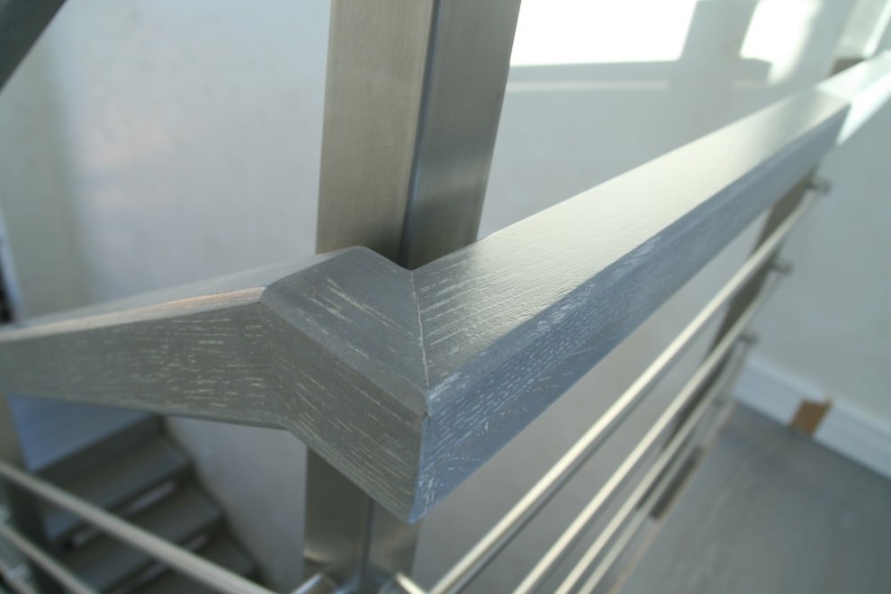 Modern metal stair covered by patina oak