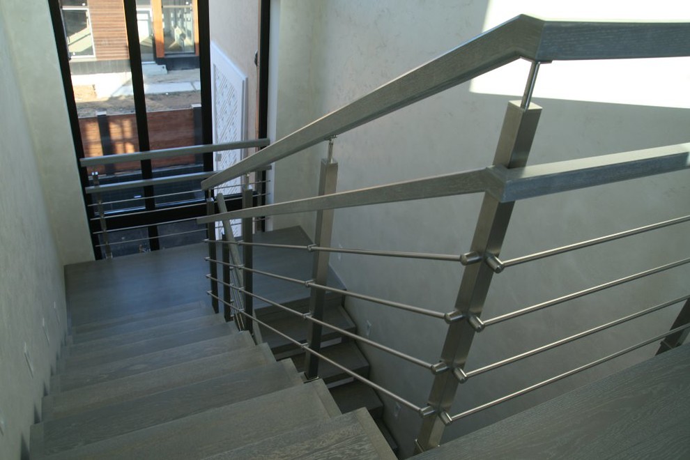 Modern metal stair covered by patina oak