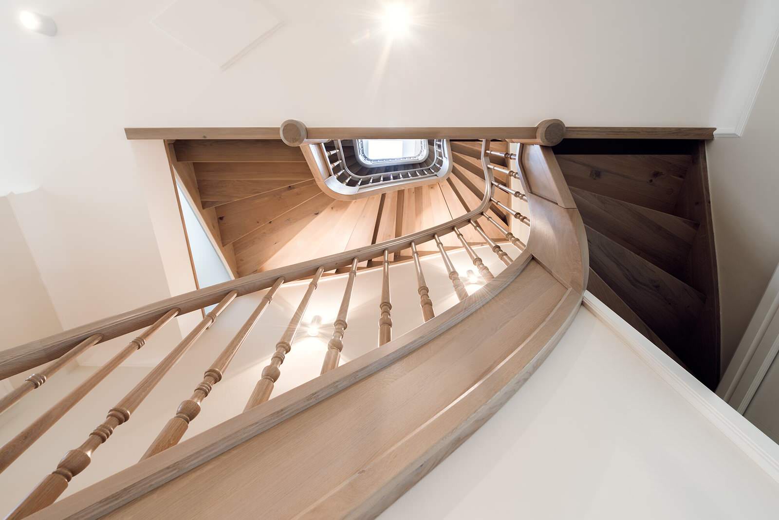 Классическая лестница из дуба с изогнутыми перилами